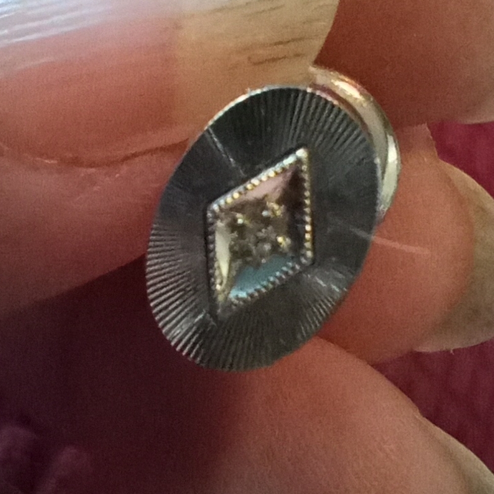 Silver tie tack with stone in center, stamped on back